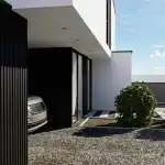 3D render of the main entrance villa SW with black fluted cladding on the ground floor and shrubbery in the front garden