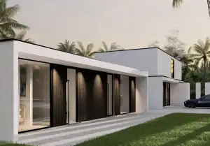 Sunset view of Villa CW featuring a minimalist single-storey structure with black vertical panels, white overhang, and a paved driveway with a parked car