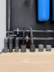 Neatly installed plumbing and water filtration system in the mechanical room of an MVIVO home