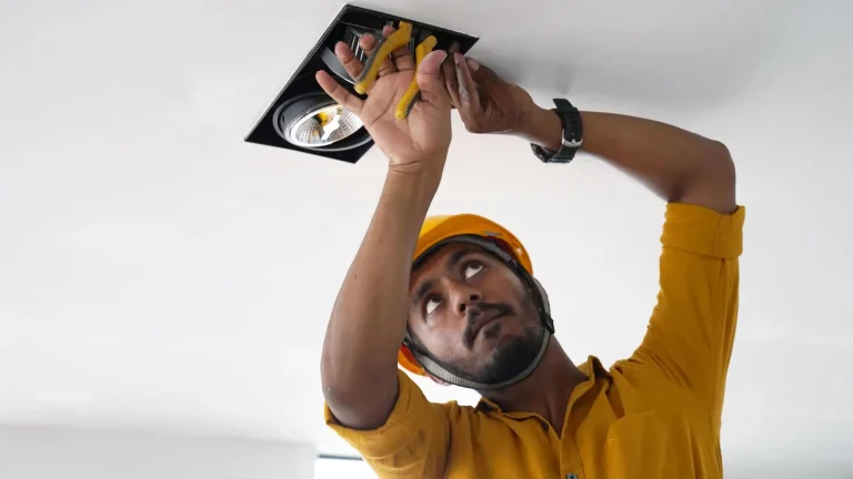 MVIVO electrician installing recessed ceiling light fixture inside a luxury home in Sri Lanka.