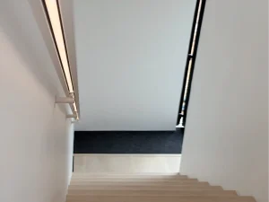 Minimalist staircase with integrated LED handrail in a modern luxury home in Sri Lanka.