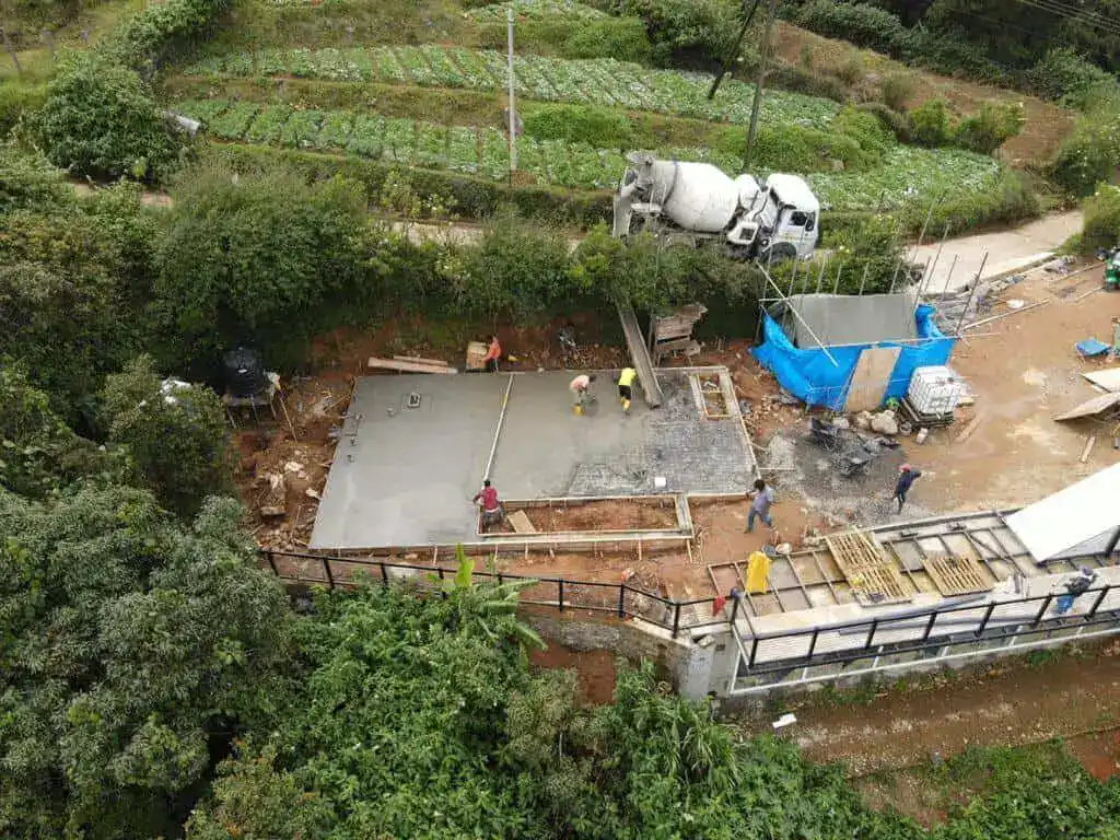 Construction team pouring concrete foundations for high-end home in Sri Lanka
