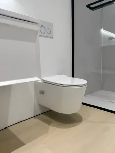 Wall-hung toilet with concealed flush tank and seamless junctions in a modern bathroom.